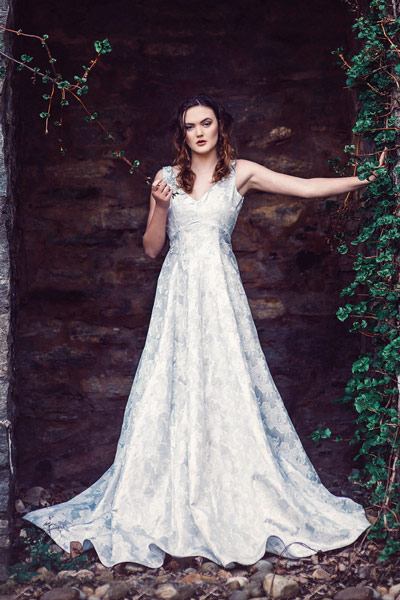 Faye wearing a full length custom made silver floral ball gown by Angela Kim