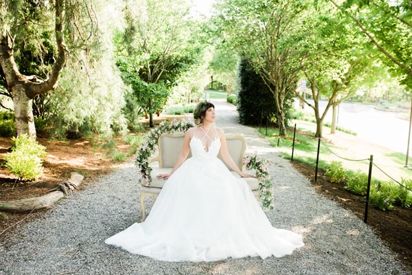 Betsabe wearing a custom wedding dress by Angela Kim Couture at the Asheville Arboretum