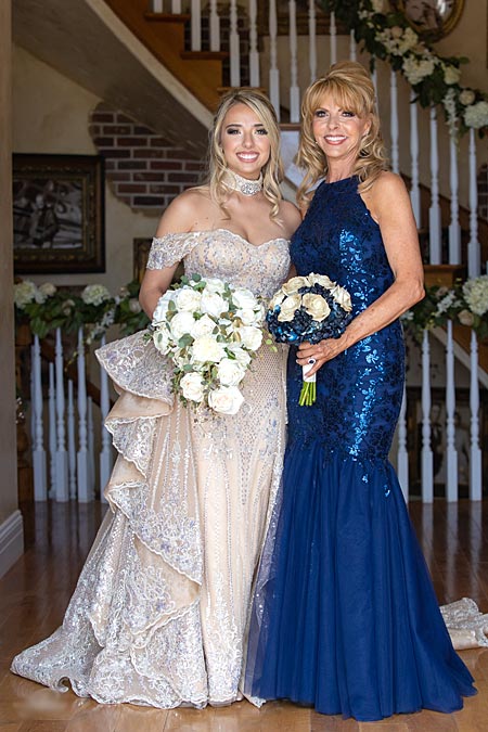 Natalia and her mom wearing their custom bridal dresses from Angela Kim Couture.