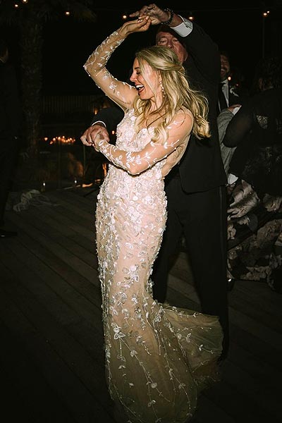 Breigh dancing in her one of a kind custom wedding dress by designer Angela Kim