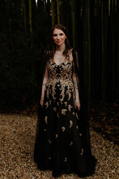 Avee posing in her black custom wedding dress