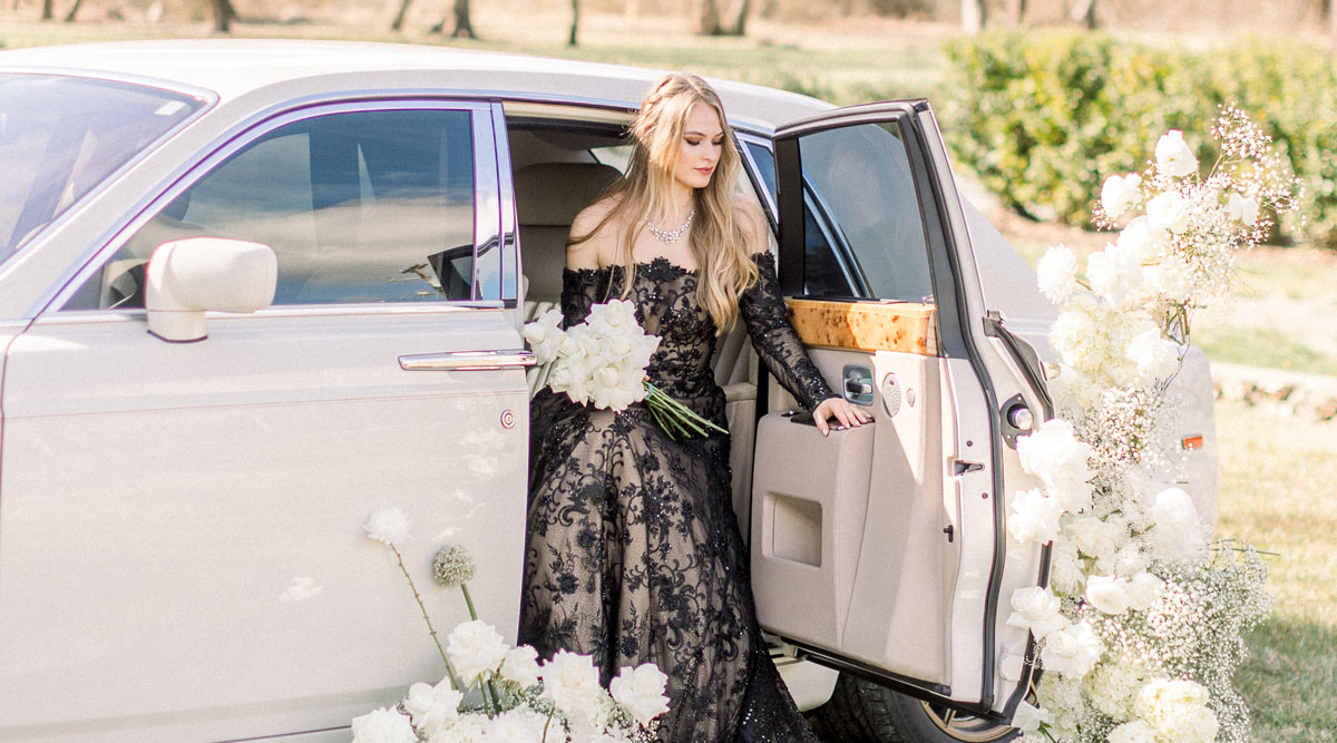 Payton wearing a black wedding dress in a white limo