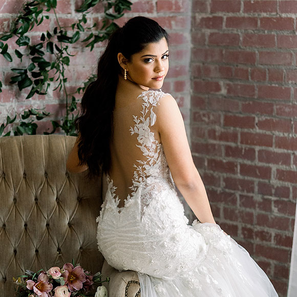 Sofia looking over her shoulder in her custom bridal gown form Angela Kim Couture