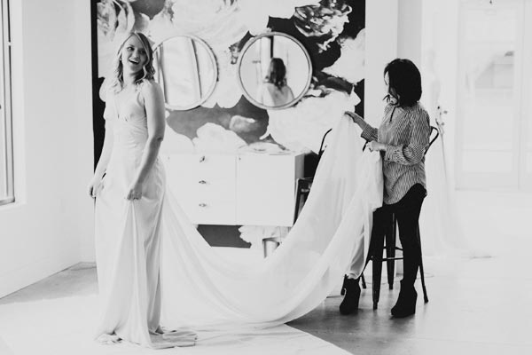 Angela styling a bride in a custom wedding dress