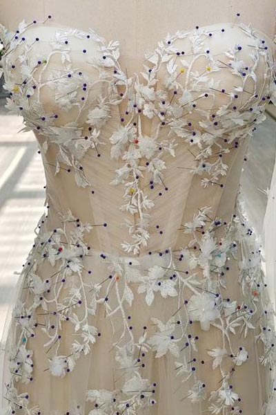 Lace appliques pinned to a dummy