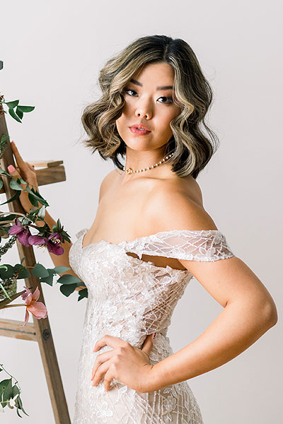 Hannah posing in a sexy off the shoulder wedding dress