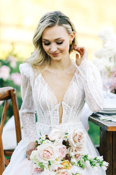 Natalie in a wedding gown with a plunging neckline