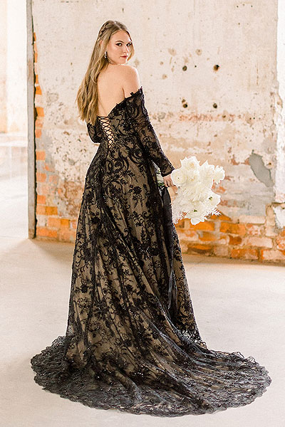 Payton looks over her shoulder in a black wedding gown