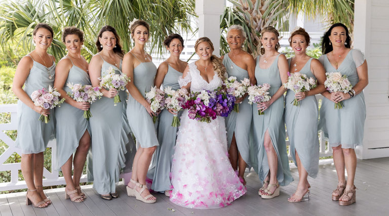 Ellen posing in her custom wedding dress with her bridesmaids