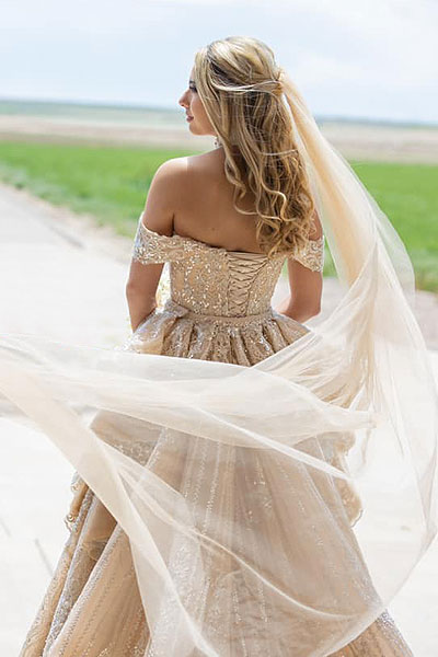 Natalia wearing her custom gold wedding dress