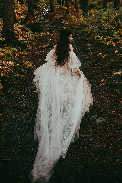 Wedding dress with royal train in the woods