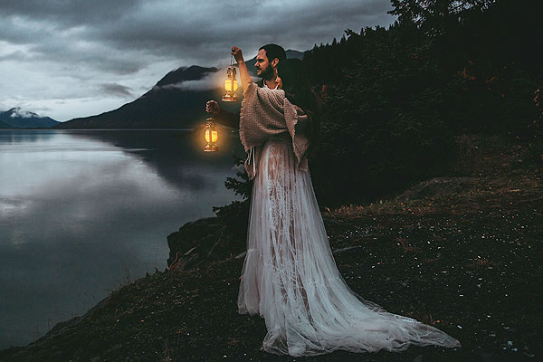 Caroline holding a lantern in her wedding dress