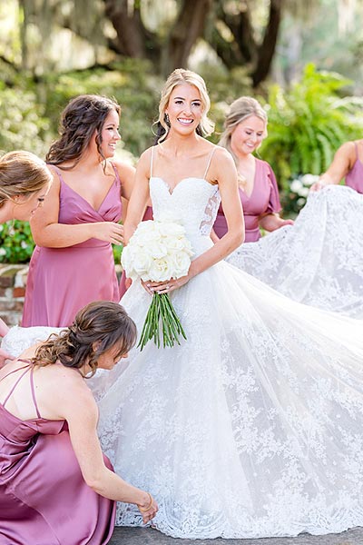 Erin's bridesmaids helping her prepare the wedding dress