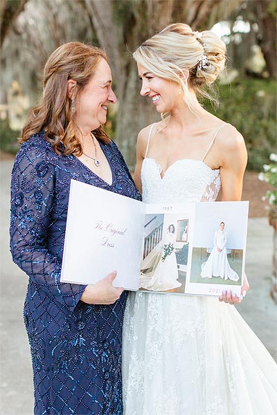 Erin posingin her wedding dress with her mother