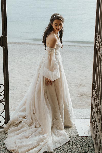 Morgan standing by the beach in her wedding dress