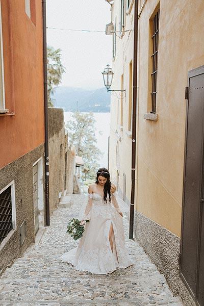 Morgan walking through an alley in her wedding gown