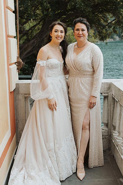 Morgan and her mother posing in their custom dresses from Angela Kim Couture