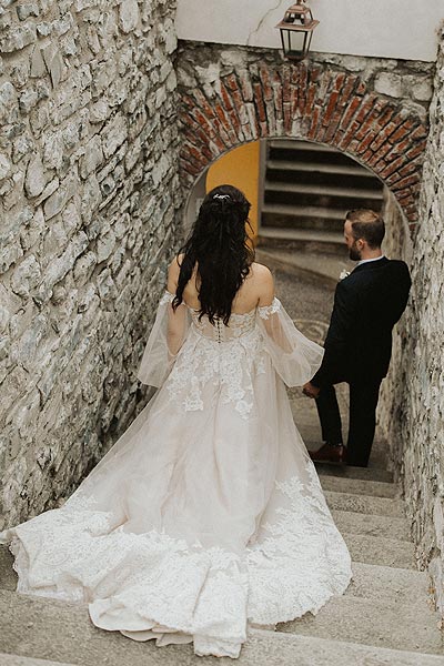 Morgan descending some stairs in her wedding dress