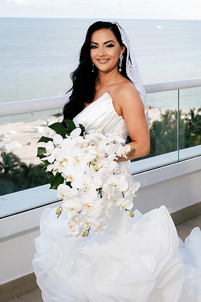 Chesea in her custom wedding dress with bouquet