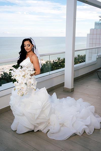 Chelse aposing in her wedding dress on a deck
