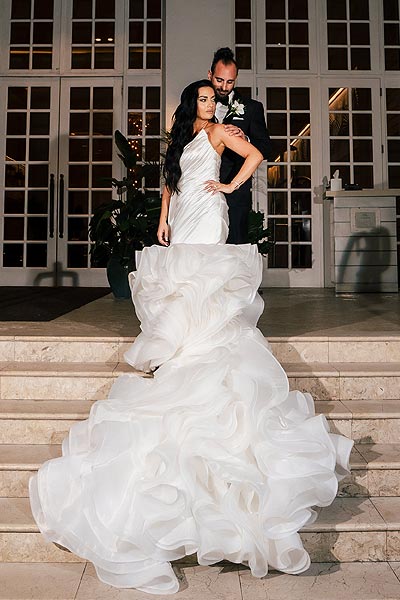 Chelsea posing in her custom wedding gown