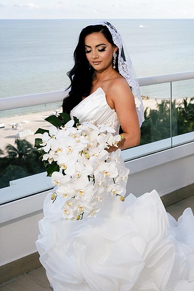Chelsea posing in her bridal gown with a bouquet