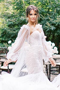 Oksana posing in her custom bridal gown