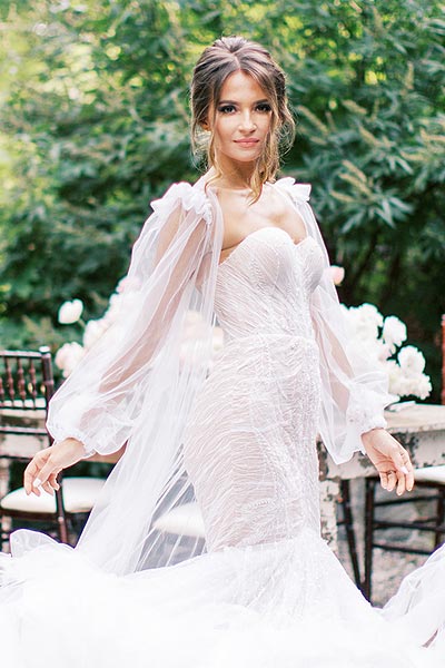 Oksana posing in her custom wedding gown