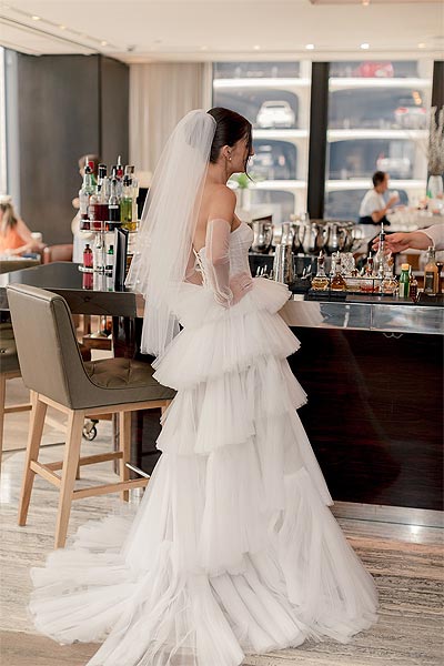 Rachel in her wedding gown at the bar