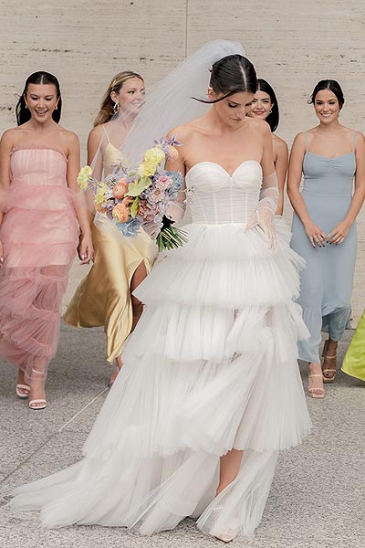Rachel in her wedding dress with her bridesmaids