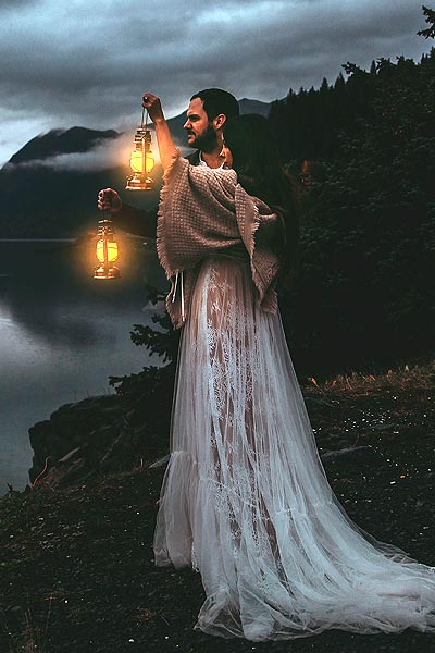 Caroline posing in her wedding dress with a lantern
