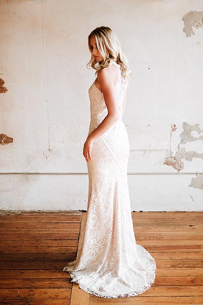 Casey wearing a lace wedding dress with a sweep train