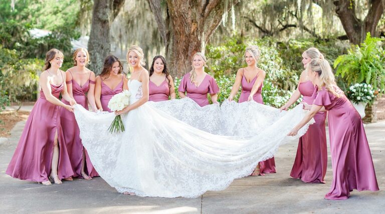 Erin's bridesmaids spreading out her custom wedding dress train