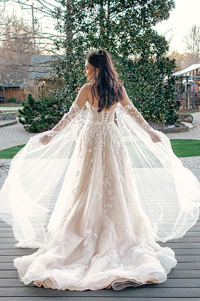 Masha's custom wedding gown features a chapel train