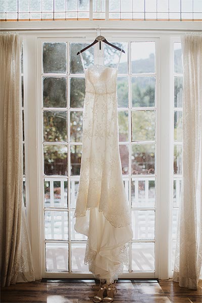 Jessica's custom wedding dress on a hanger