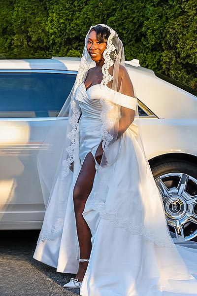 Jenneh posing in her wedding dress and veil
