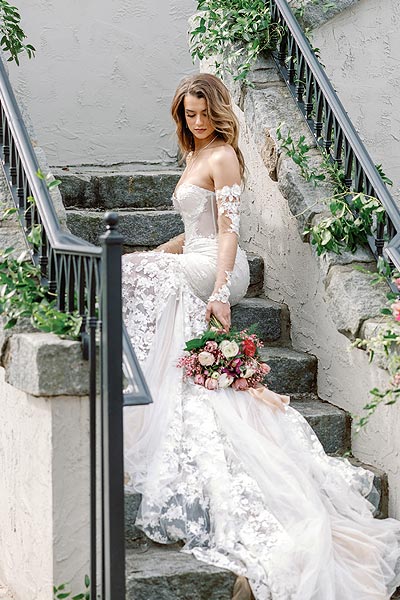 Kyra sitting on the steps in her custom gown