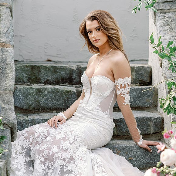 Kyra sitting in her custom wedding gown