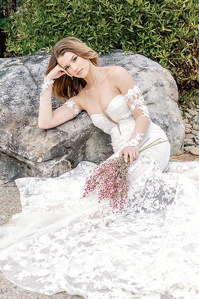 Kyra posing in her custom wedding gown