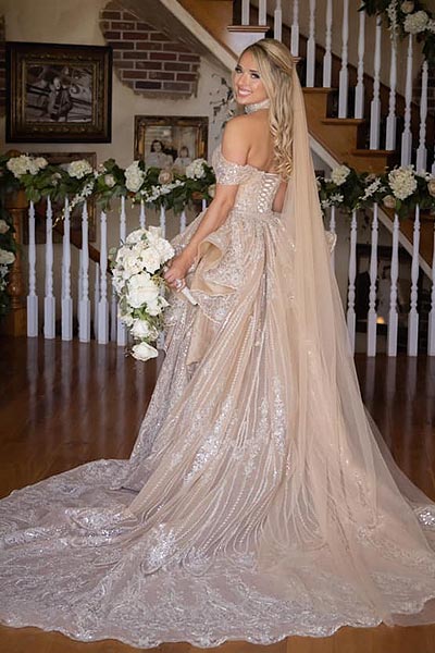 Natalia posing in her custom gold wedding dress