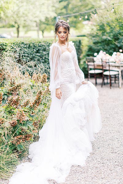 Oksana posing in her custom wedding gown
