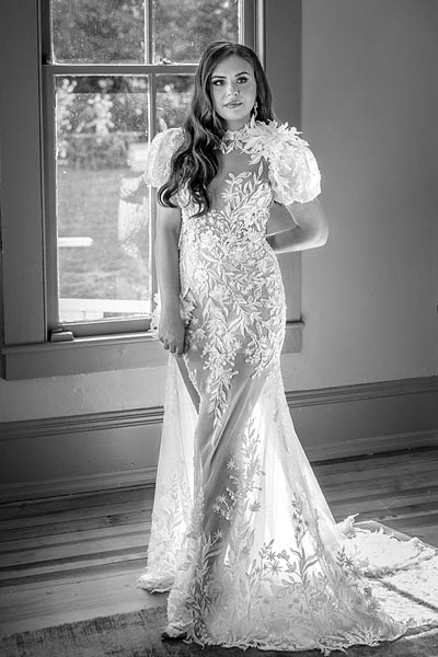 Masha posing in her custom bridal gown