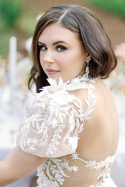 Masha looking over her shoulder in her custom wedding gown
