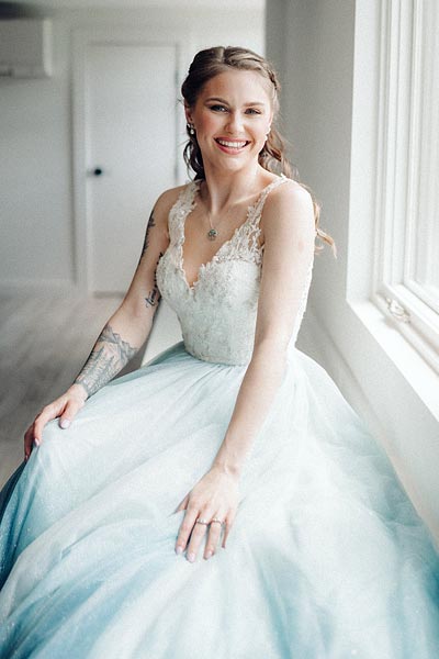 Taylor posing in her custom wedding dress