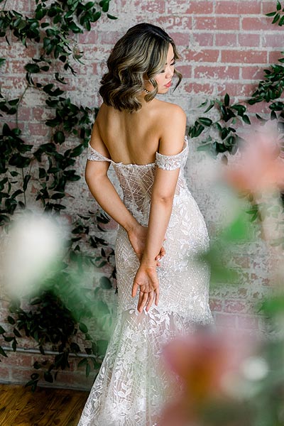 Hannah posing in her custom backless wedding dress