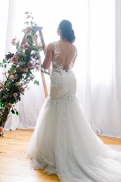 Sofia posing in her custom backless wedding gown