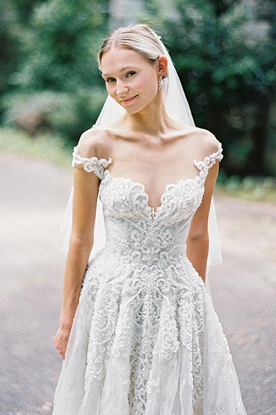 Natalie wearing her custom wedding dress with a portrait neckline