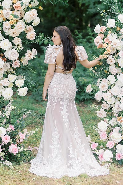 Masha posing in her custom summer wedding gown