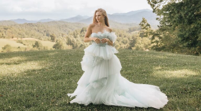 Payton posing in her blue summer wedding dress
