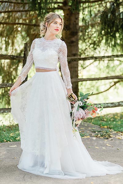 Taylor posing in a wedding dress with a jewel neckline